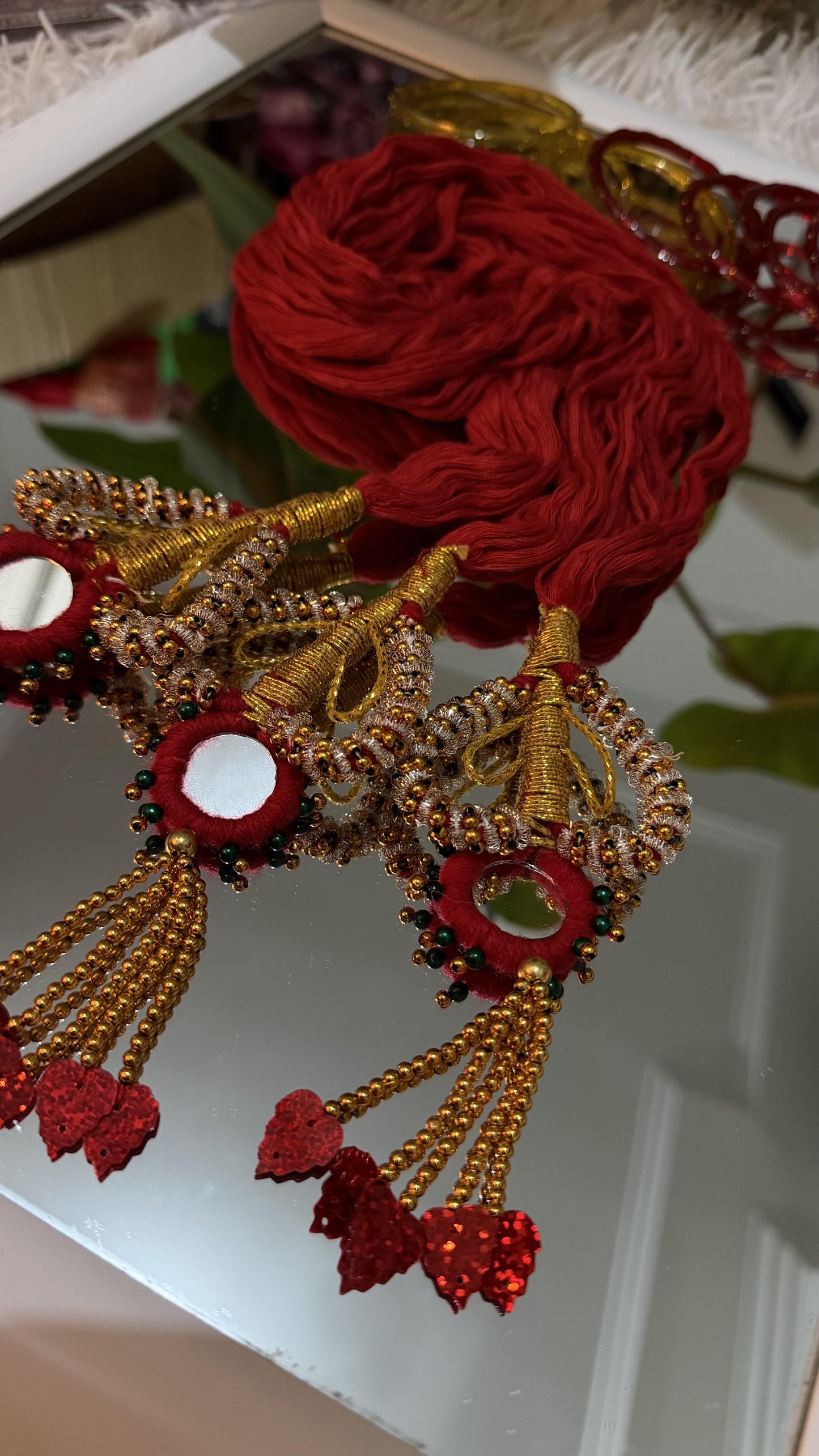 Handcrafted crimson red and gold Lachha Dori with mirror centres, zari wrapping, gold bead tassels and red sequin leaf drops — view 3