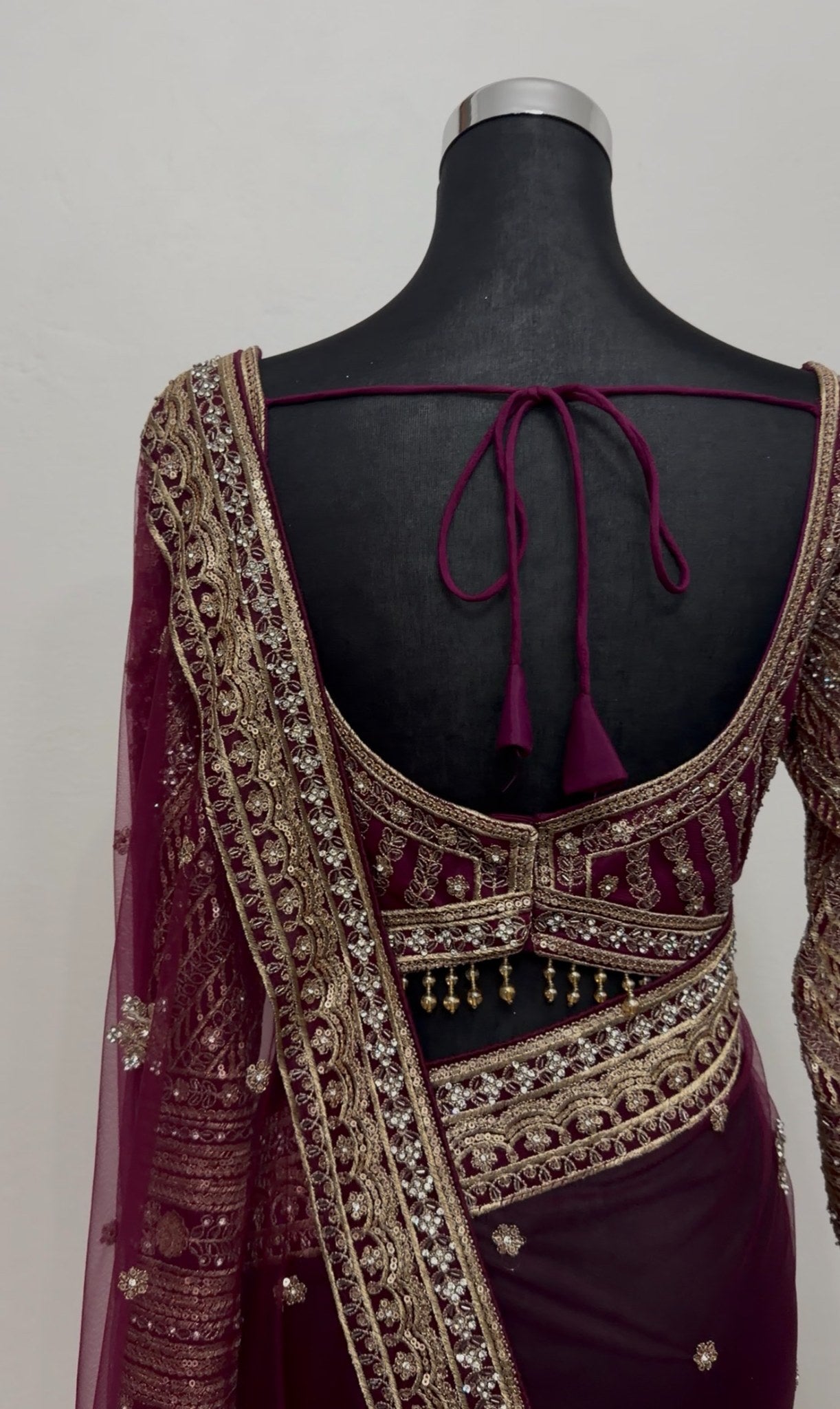 Burgundy organza saree with gold zari floral motifs and embroidered border, worn with matching full-sleeve embroidered — view 6