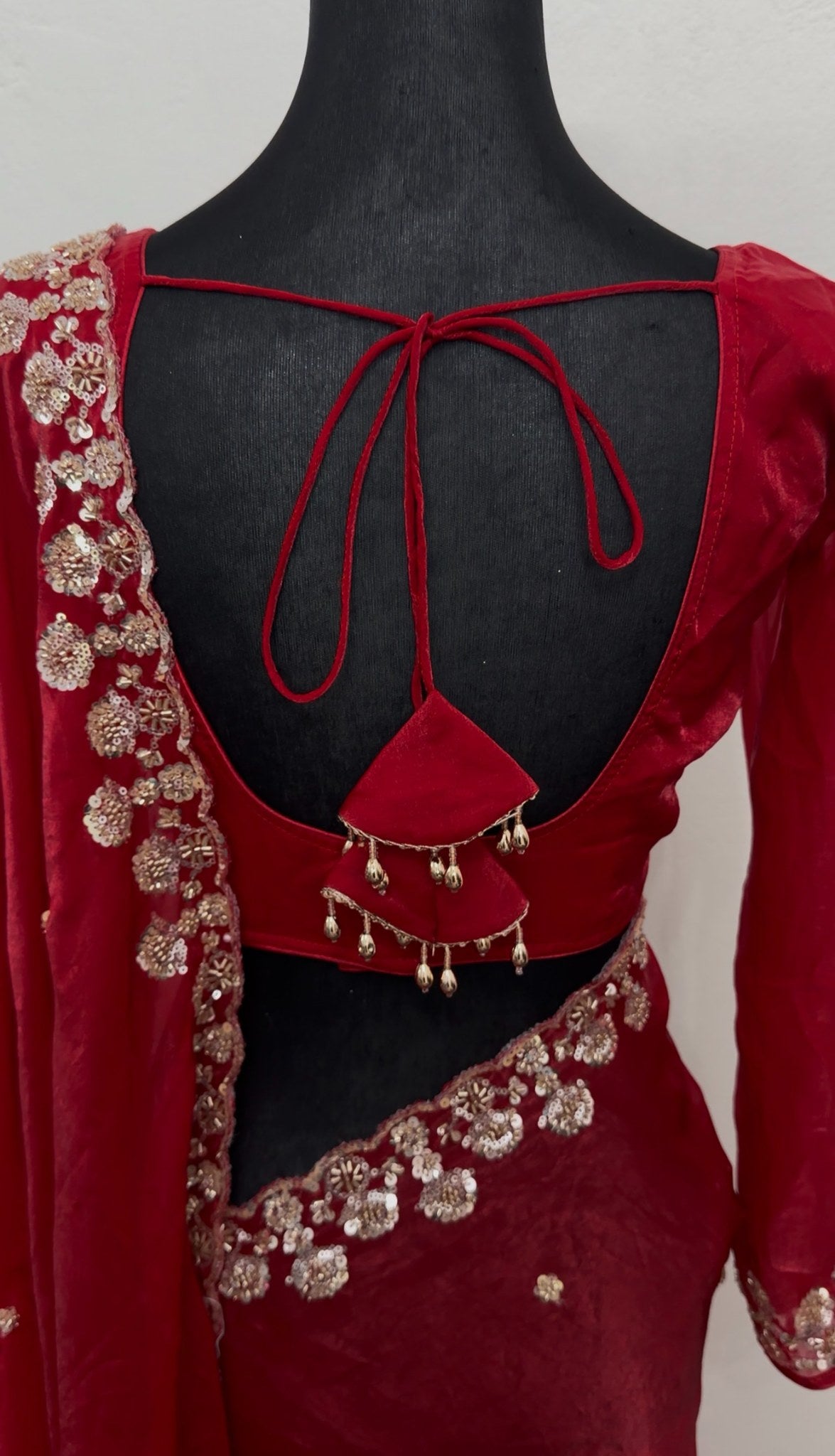 Red saree with silver sequin floral embroidery on border and pallu, draped with matching full-sleeve blouse — view 6