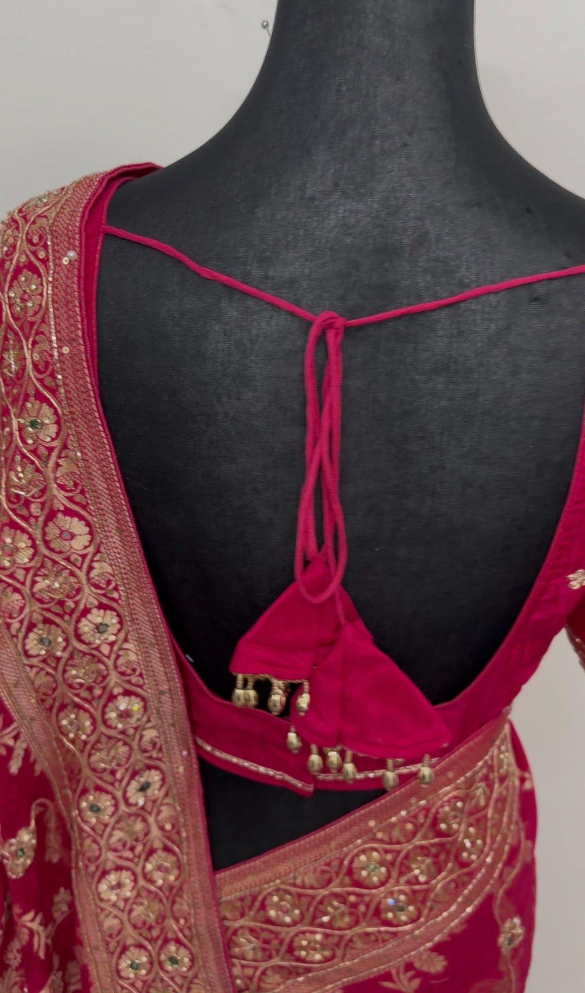 Magenta khaddi georgette saree with gold zari floral embroidery and embellished border worn with matching blouse — view 8