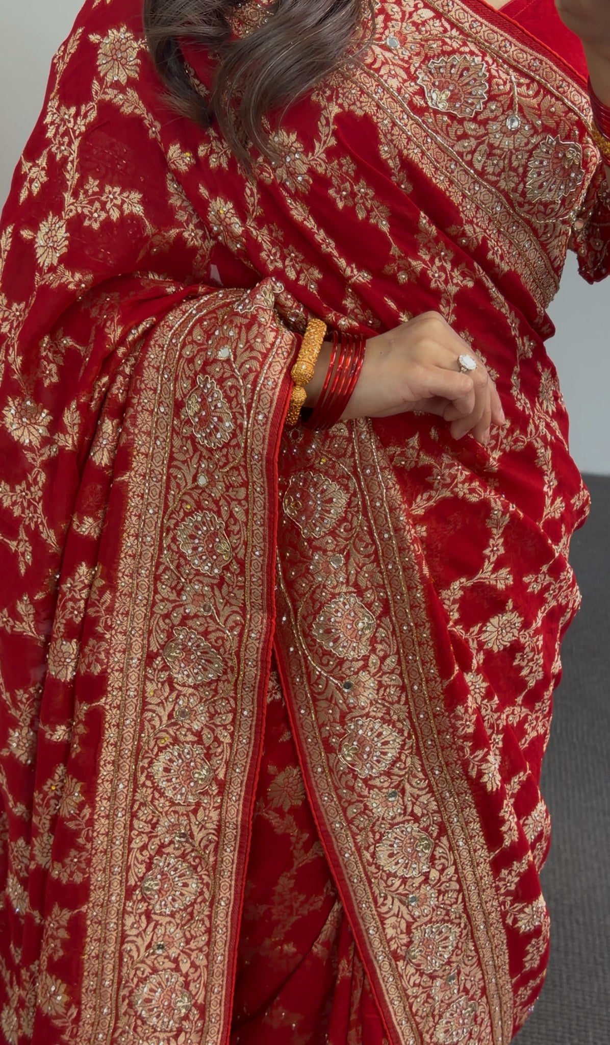 Red khaddi georgette saree with gold zari embroidery and floral border design worn with matching red blouse — view 5