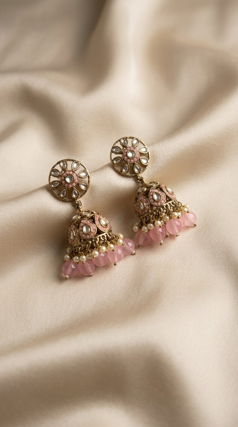 Gold-toned kundan jhumka earrings with cage dome, oval stone setting and cascading lavender bead drops on ivory silk — — Pink