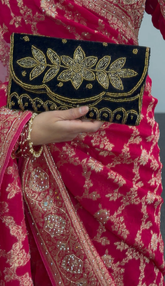 Black embroidered clutch bag with gold beadwork floral design and scalloped border detailing — view 2