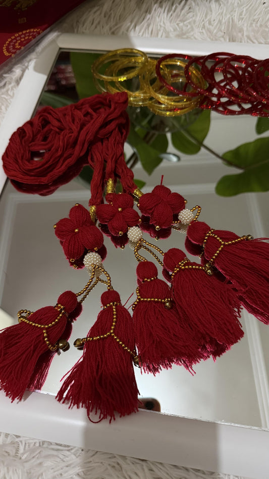 Crimson red handcrafted Lachha Dori with floral yarn motifs, faux pearl clusters, gold seed beads and tassel detail — Behuli