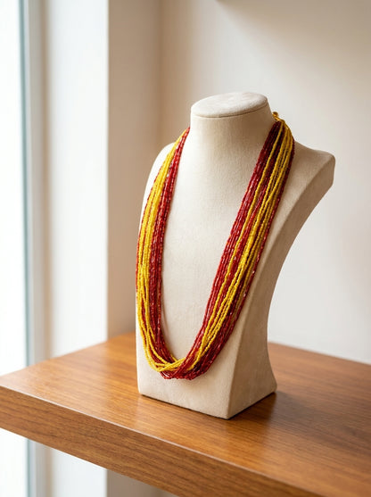 Multi-strand crimson red and golden yellow glass seed bead Potey necklace on display bust — Behuli Australia