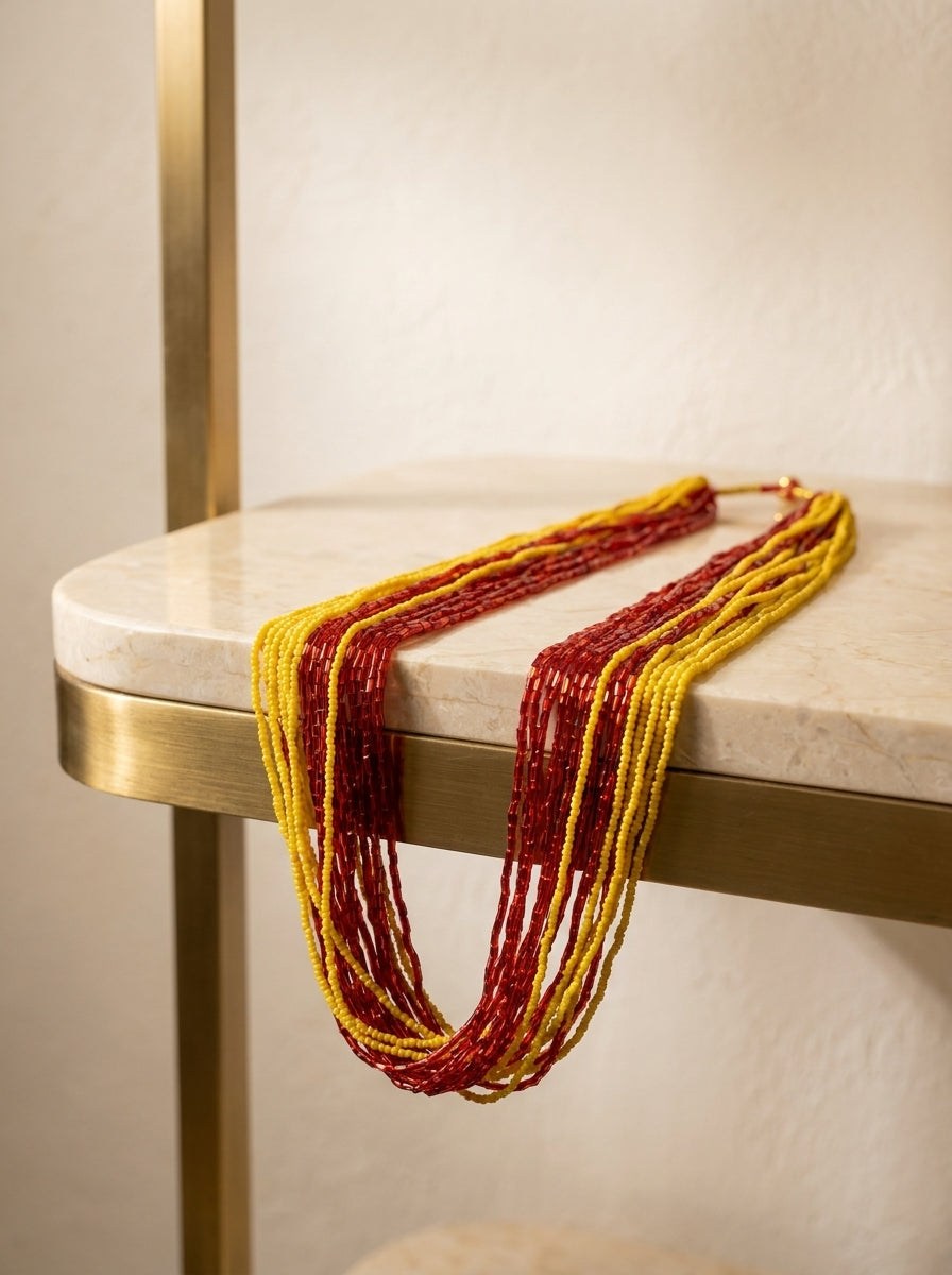 Multi-strand crimson red and golden yellow glass seed bead Potey necklace on display bust — Behuli Australia — view 2