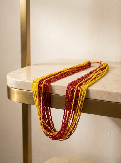 Multi-strand crimson red and golden yellow glass seed bead Potey necklace on display bust — Behuli Australia — view 2