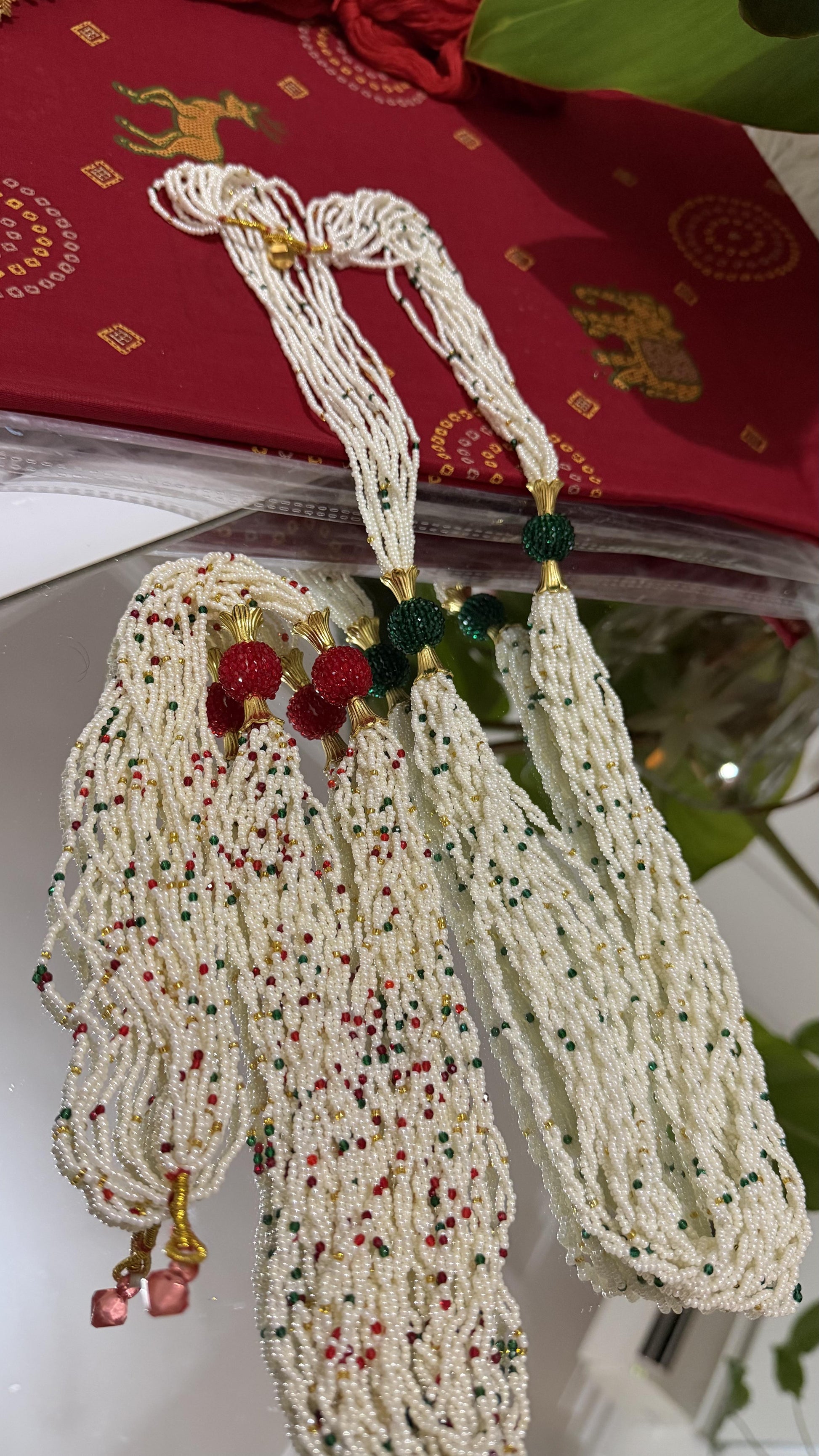 Ivory multi-strand seed bead potey necklace with emerald green beads and gold floral cap centrepiece balls — Behuli Australia — view 3