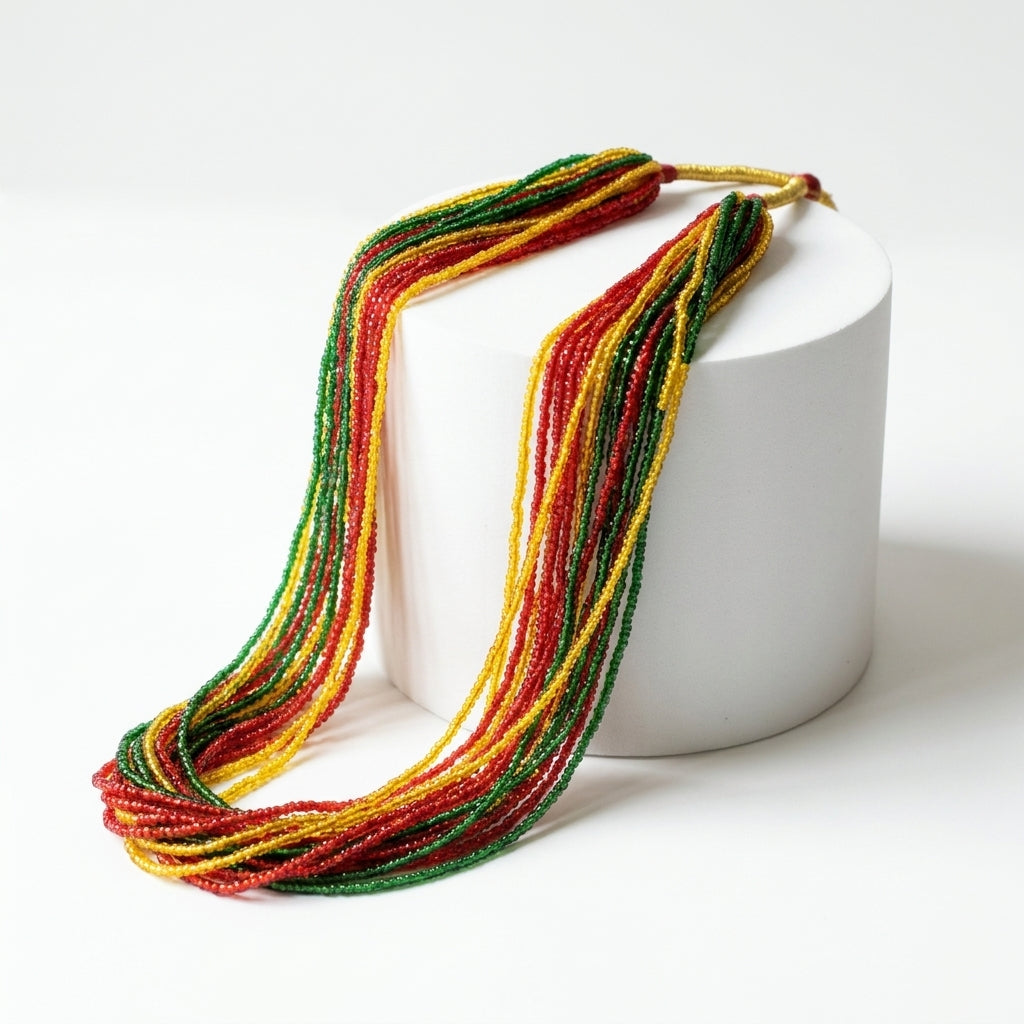 Multi-strand tri-colour red yellow and green seed bead statement necklace displayed on white stand — Behuli Australia — view 2