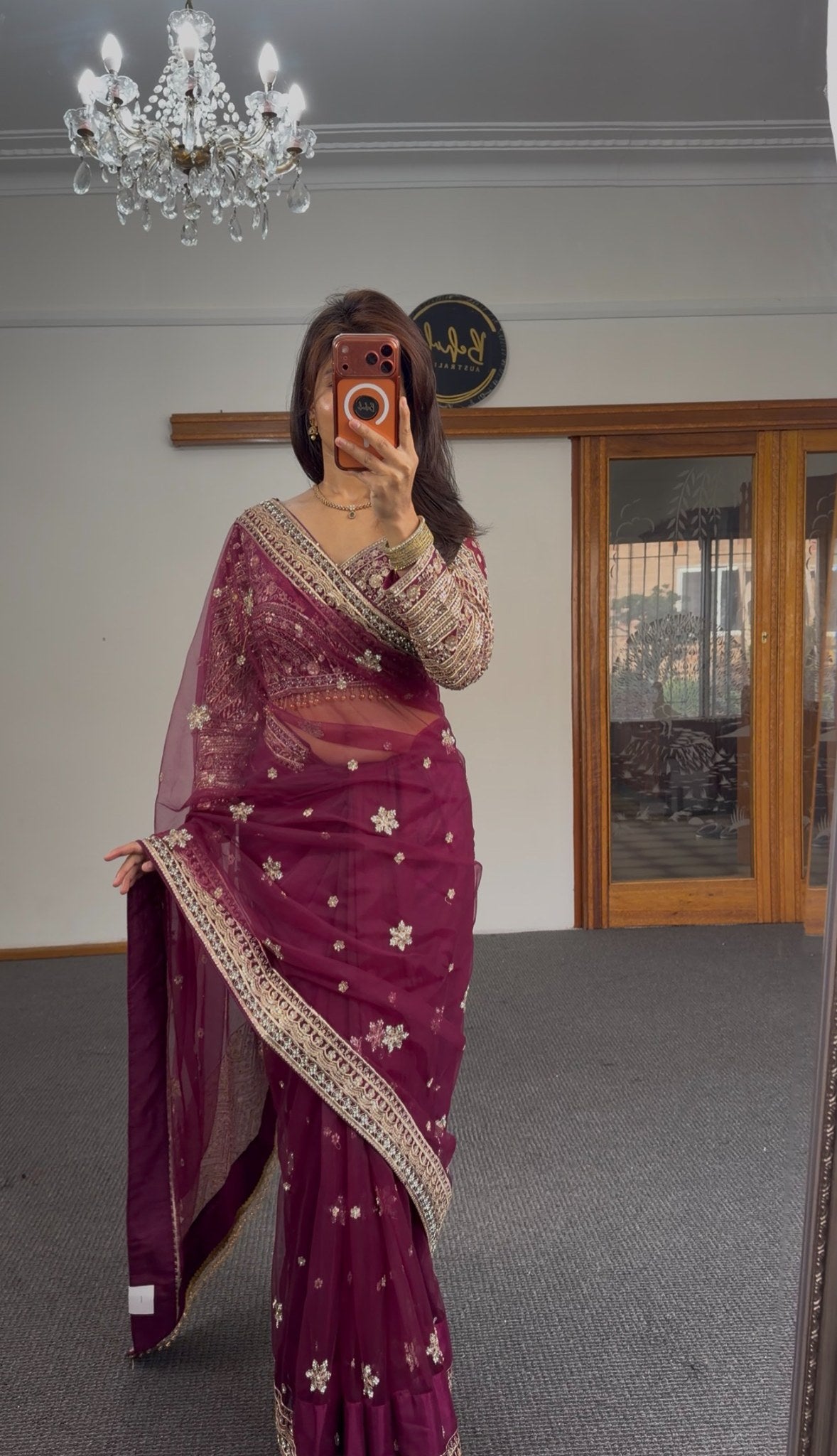 Burgundy organza saree with gold zari floral motifs and embroidered border, worn with matching full-sleeve embroidered — view 3