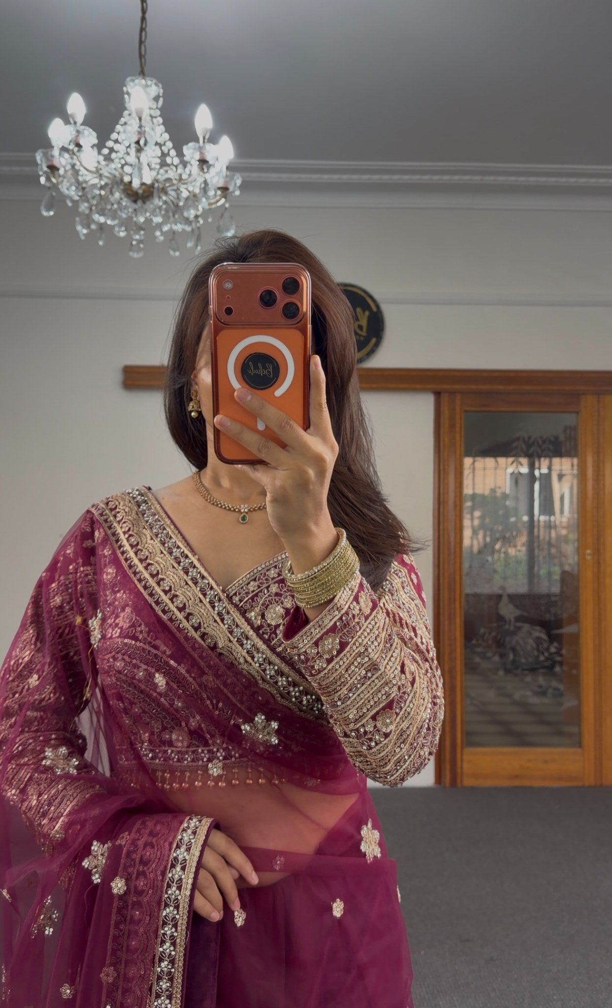 Burgundy organza saree with gold zari floral motifs and embroidered border, worn with matching full-sleeve embroidered — view 4