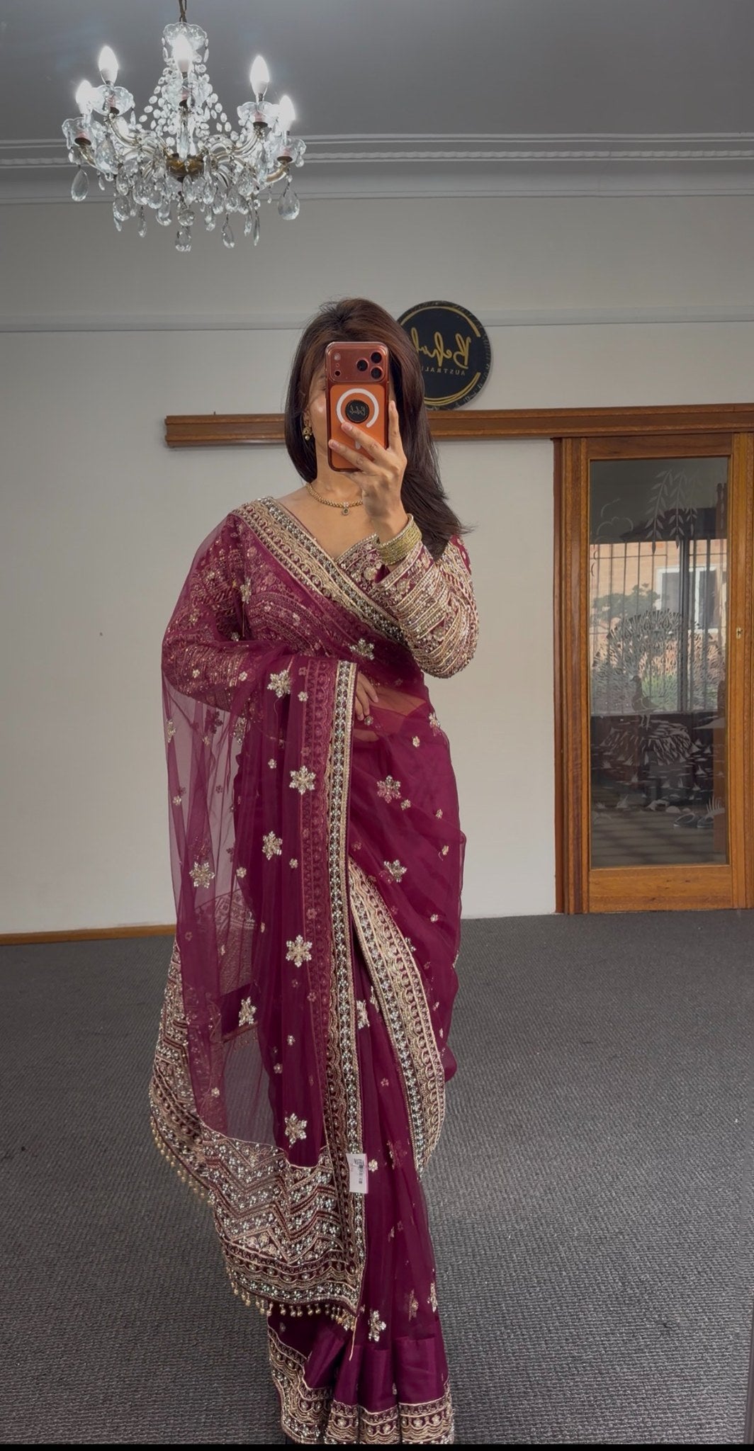 Burgundy organza saree with gold zari floral motifs and embroidered border, worn with matching full-sleeve embroidered — view 2