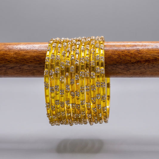 Yellow crystal glass bangles with silver rhinestone floral cluster detailing stacked on wooden display — Behuli Australia