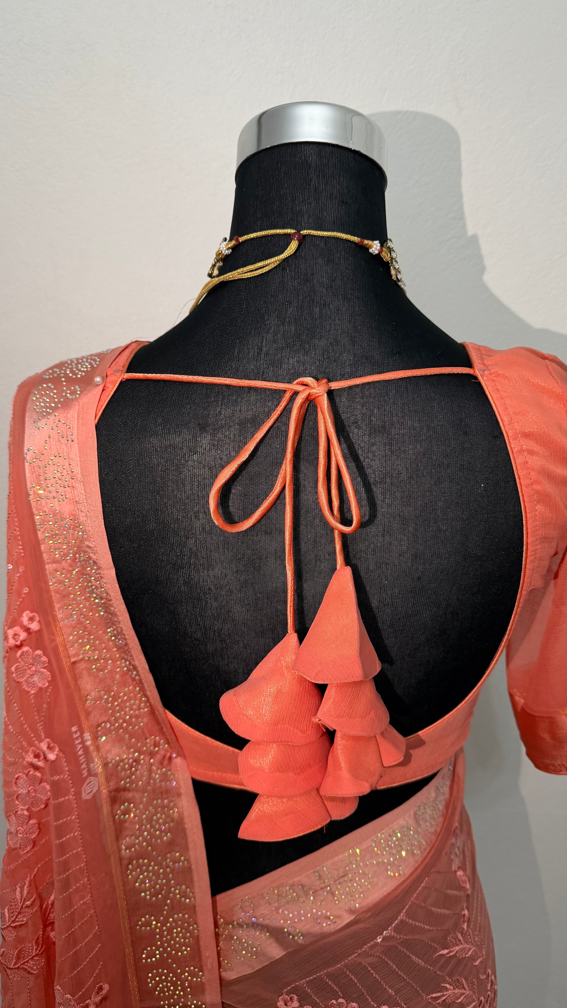 Coral peach georgette saree with floral zari embroidery, sequin work and tassel pallu — worn with matching peach blouse, — view 5