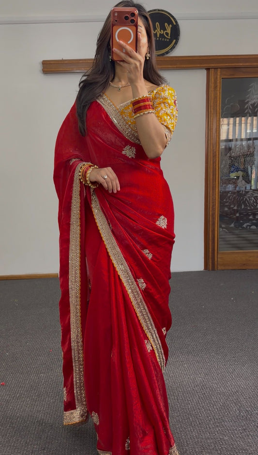 Bridal red pure silk saree with gold zari floral buti motifs and antique gold lace border, styled with a mustard embroidered