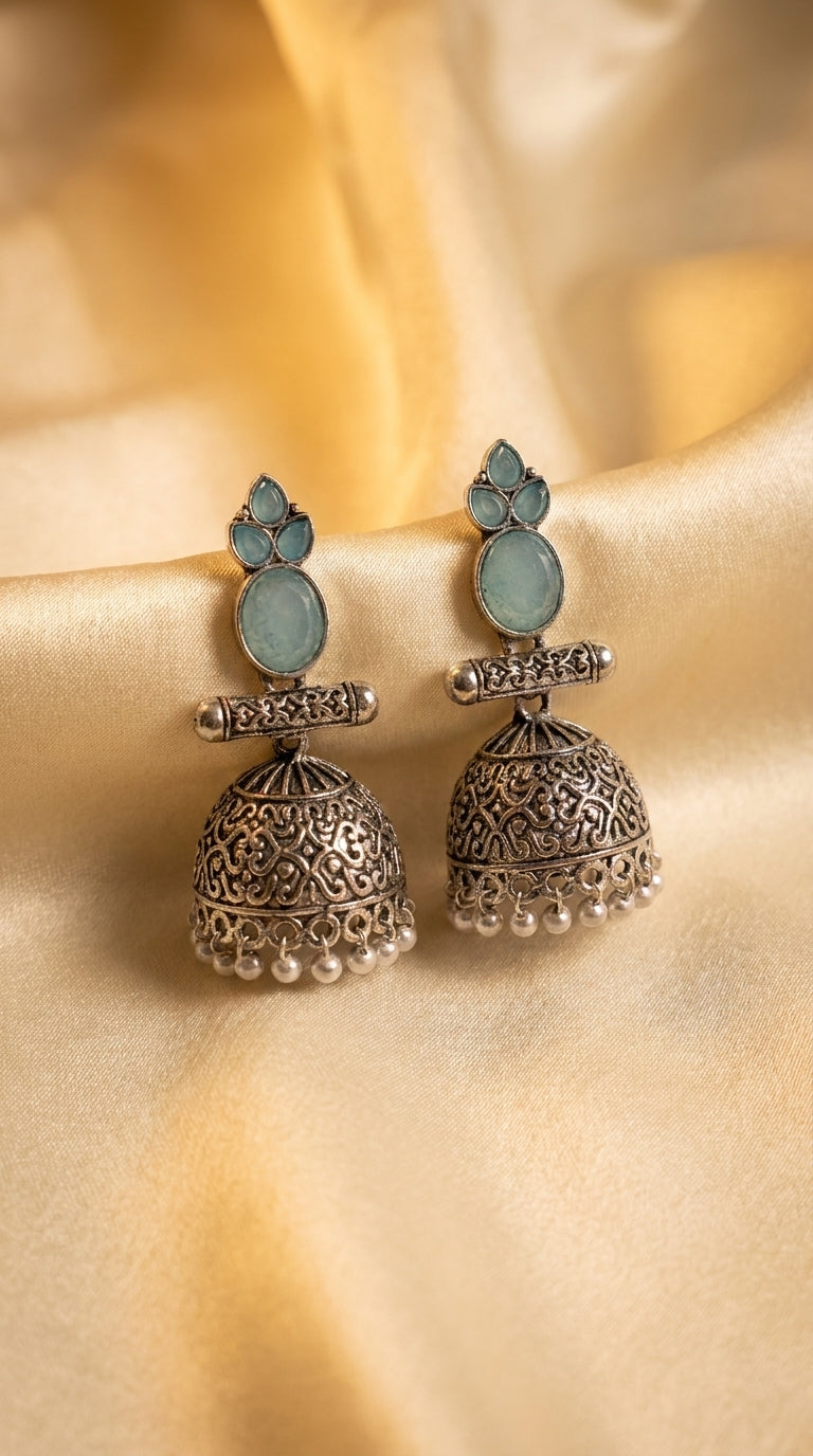 Oxidised silver jhumka earrings with aqua cabochon stones, filigree dome and ivory pearl drops on gold silk — Behuli — Aqua Blue