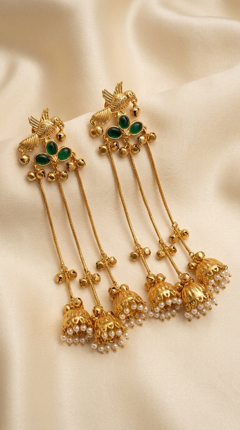 Gold-plated parrot motif jhumka earrings with green cabochon stones, multi-chain drops and pearl-trimmed bells — Behuli