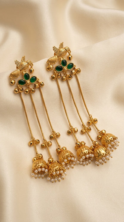 Gold-plated parrot motif jhumka earrings with green cabochon stones, multi-chain drops and pearl-trimmed bells — Behuli