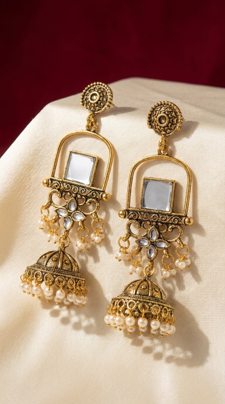 Antique gold jhumka earrings with square kundan mirror inlay, filigree scrollwork and cascading ivory pearl drops — Behuli