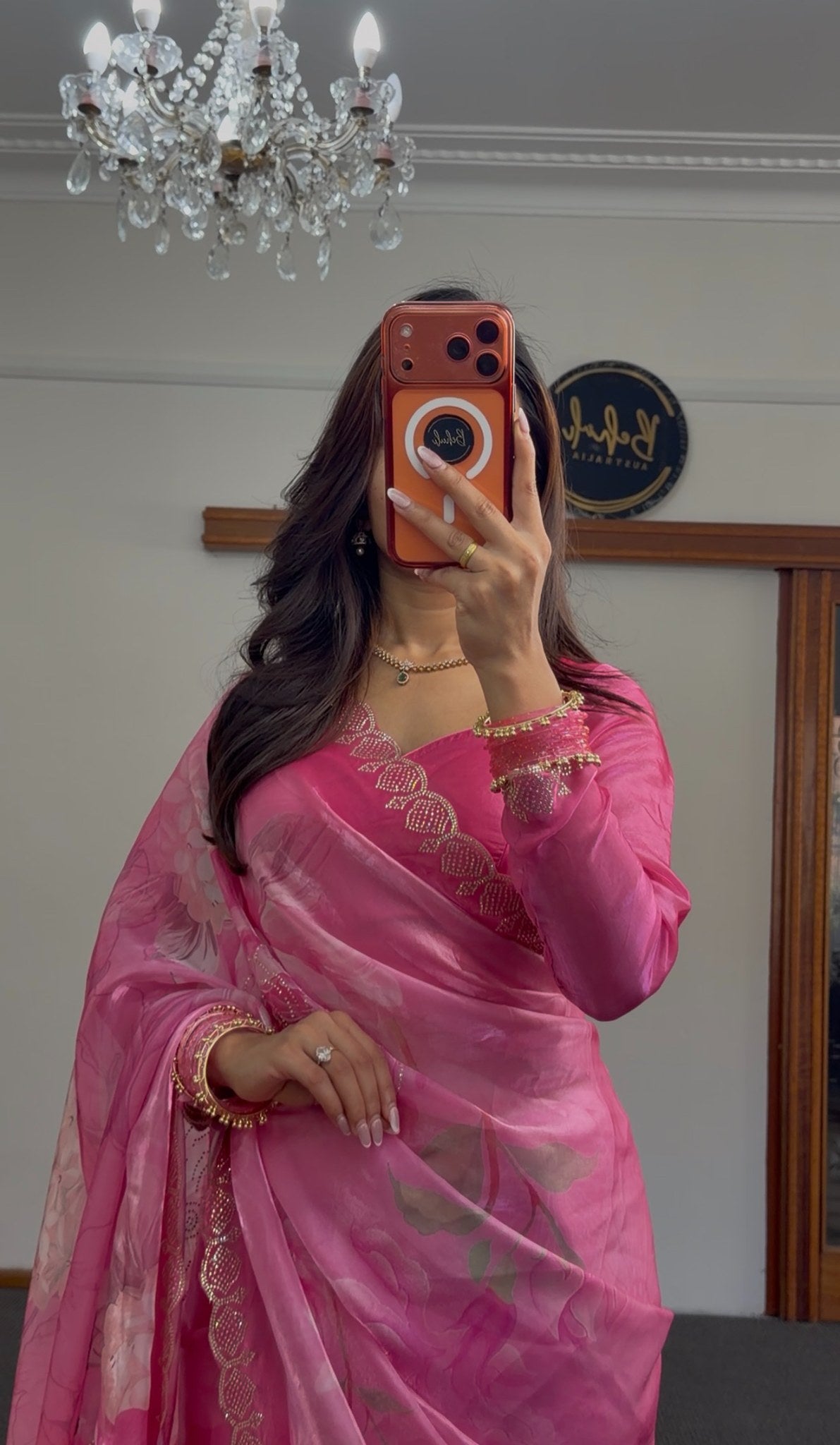 Pink floral printed saree with gold sequin border detailing and matching embroidered blouse draped elegantly — view 2