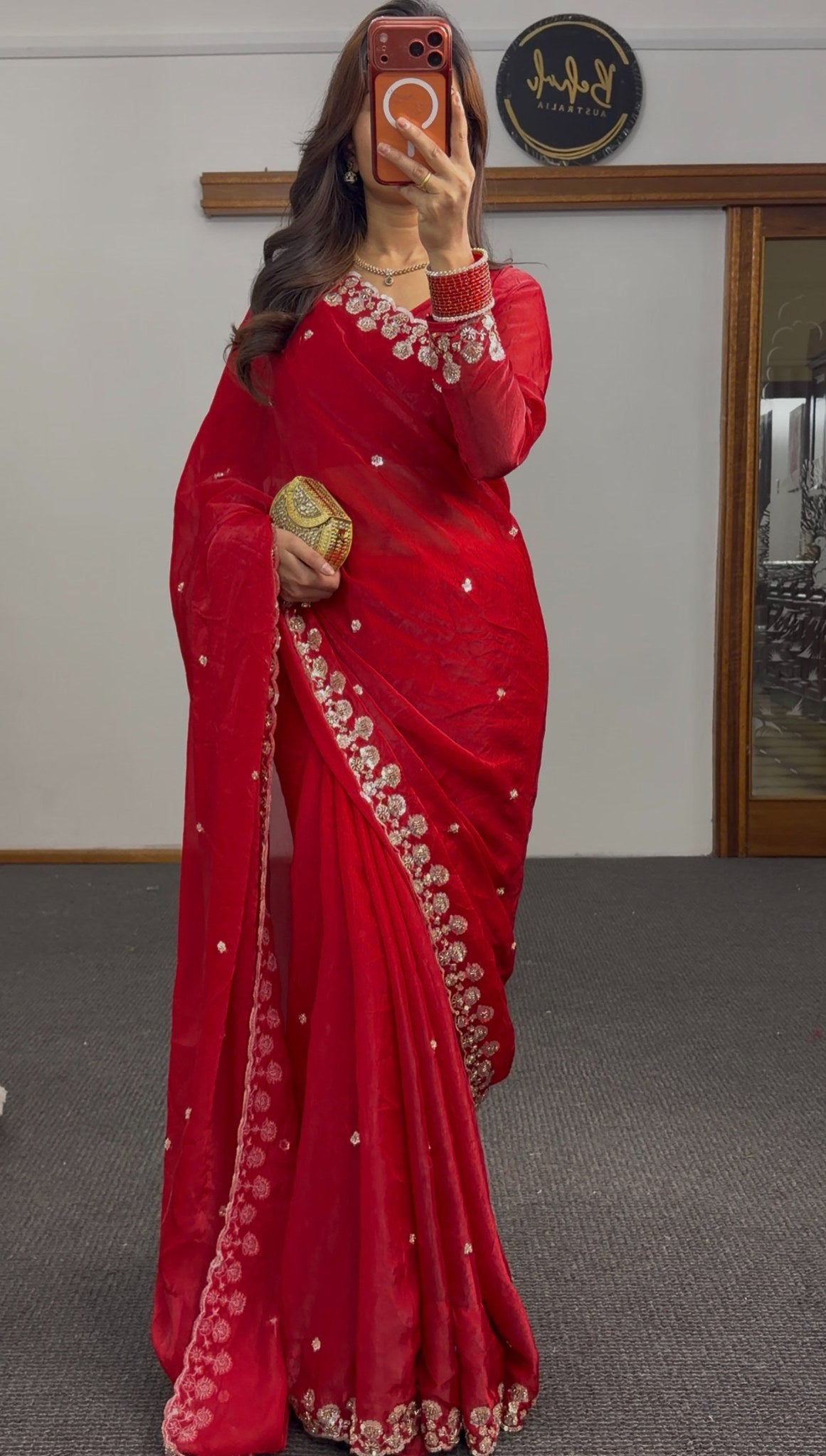Red saree with silver sequin floral embroidery on border and pallu, draped with matching full-sleeve blouse — view 2
