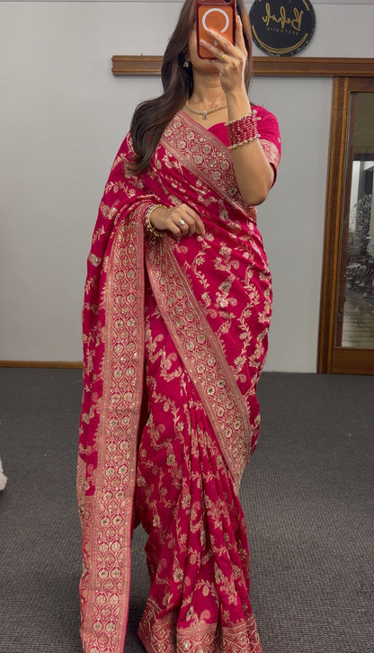 Magenta khaddi georgette saree with gold zari floral embroidery and embellished border worn with matching blouse