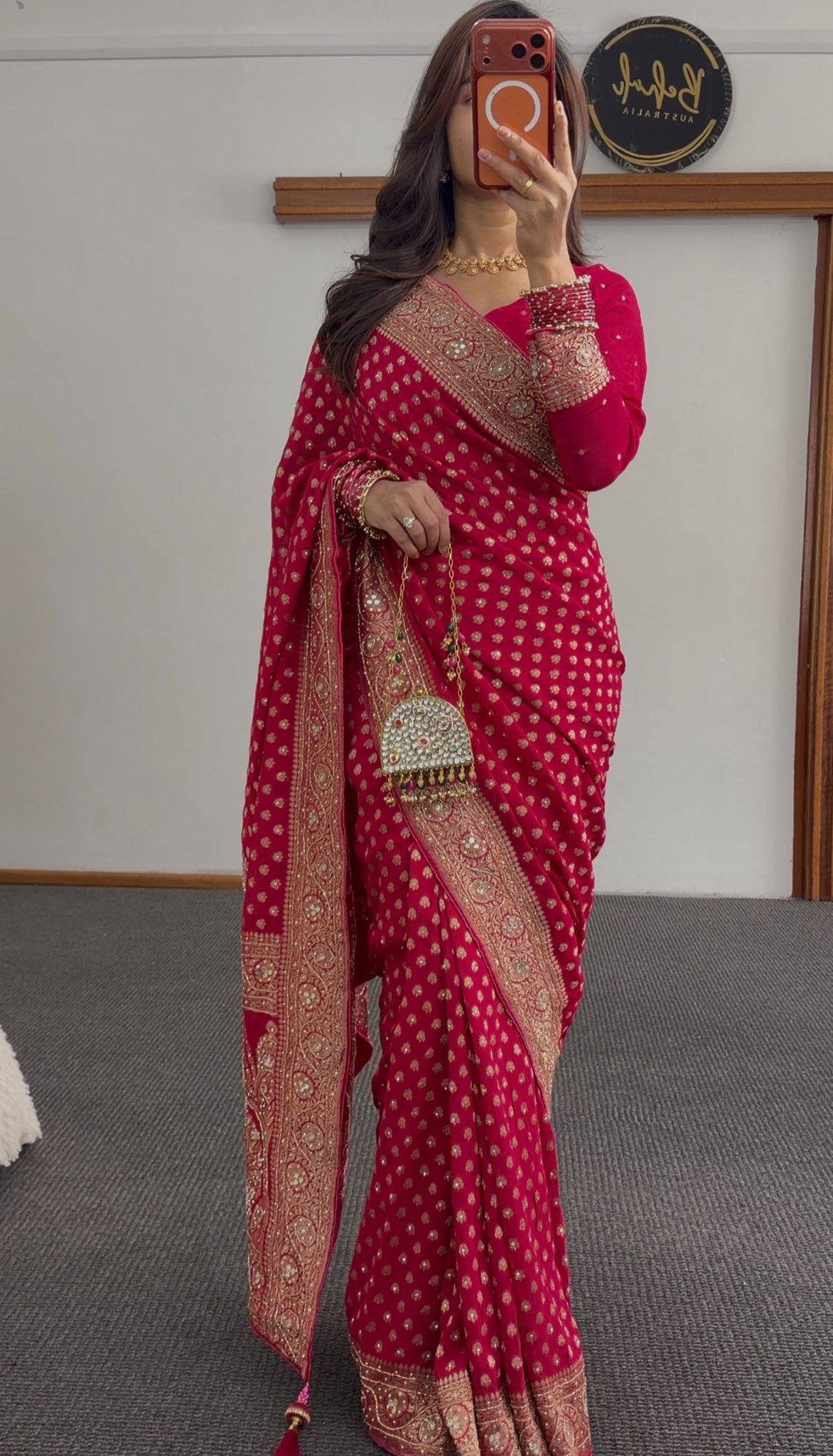 Rani pink khaddi georgette saree with gold zari butis and embellished border draped with matching blouse