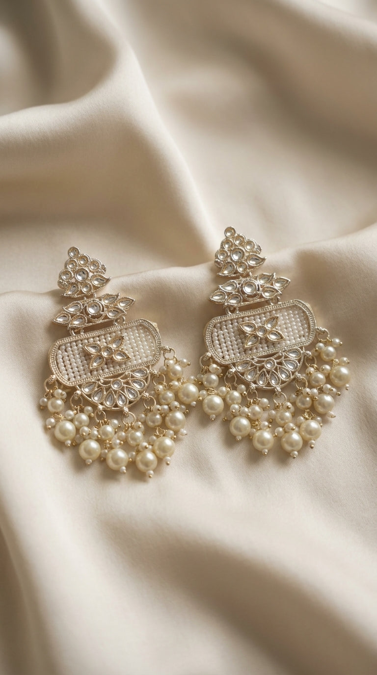 Ivory and gold-tone kundan-style drop earrings with seed bead panel and cascading pearl clusters on cream silk — Behuli — view 2