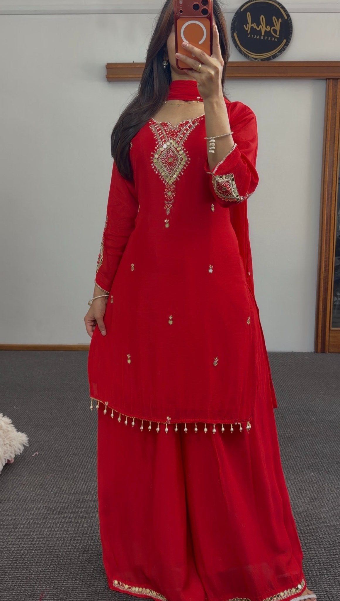 Red georgette palazzo suit set with gold sequin embroidery, mirror detailing and pearl tassels, paired with matching dupatta