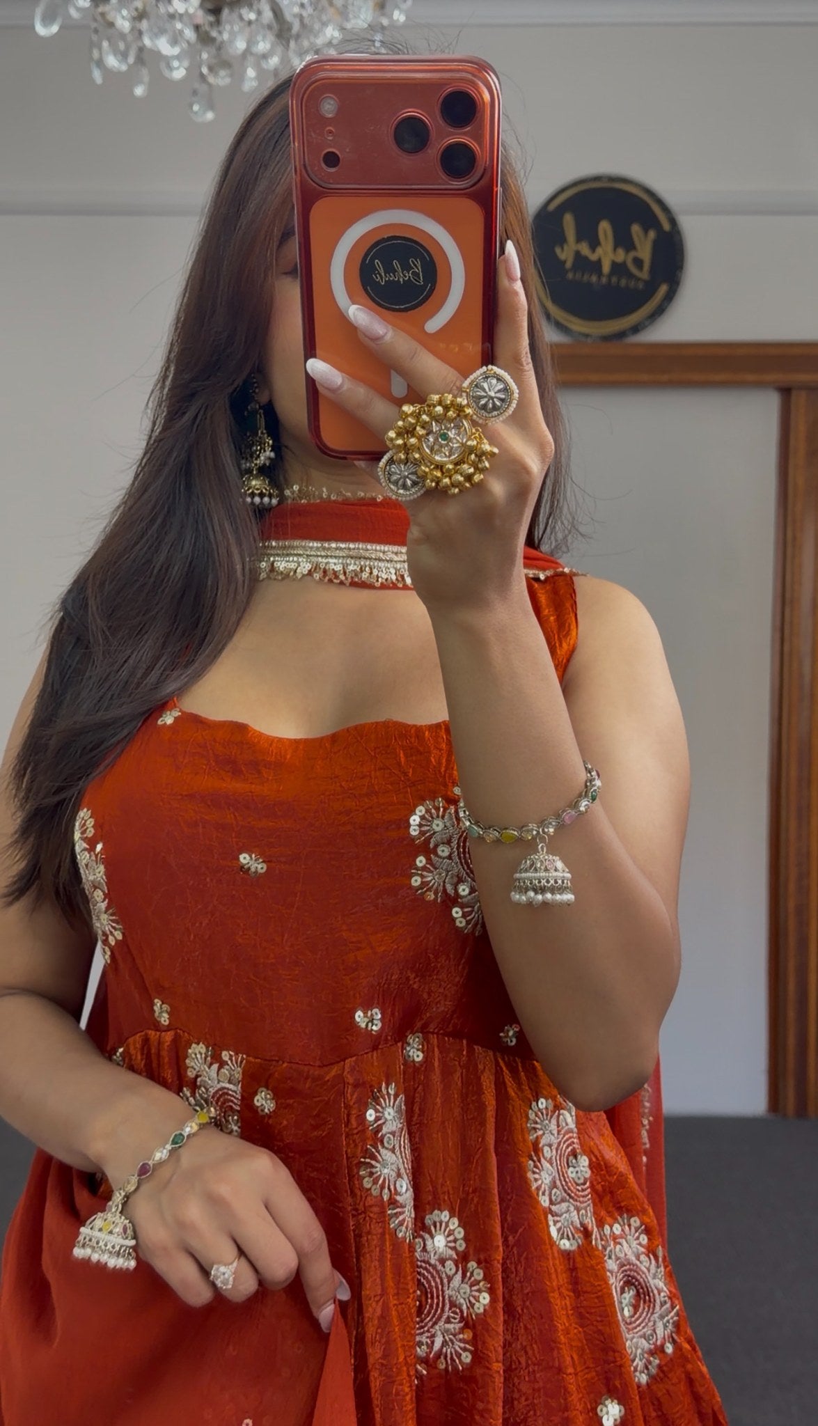 Rust orange Anarkali gown with ivory and gold circular floral embroidery, styled with gold choker and jhumka earrings — — view 2