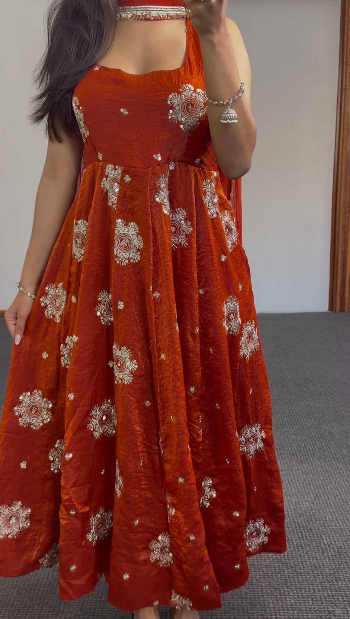 Rust orange Anarkali gown with ivory and gold circular floral embroidery, styled with gold choker and jhumka earrings — — view 3