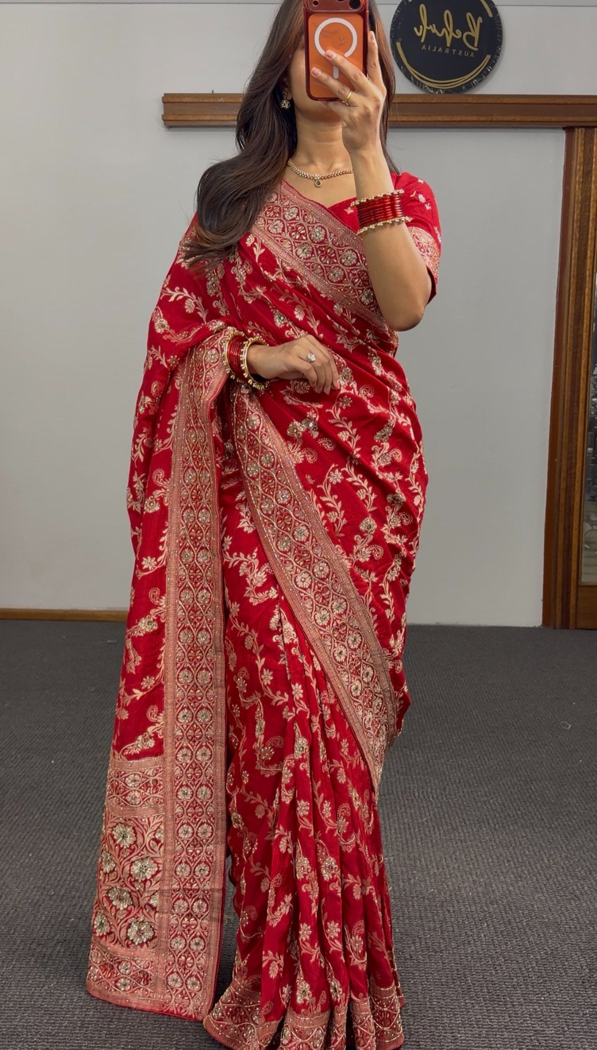 Red Khaddi georgette saree with gold zari embroidered border and sequin detailing draped with matching red blouse