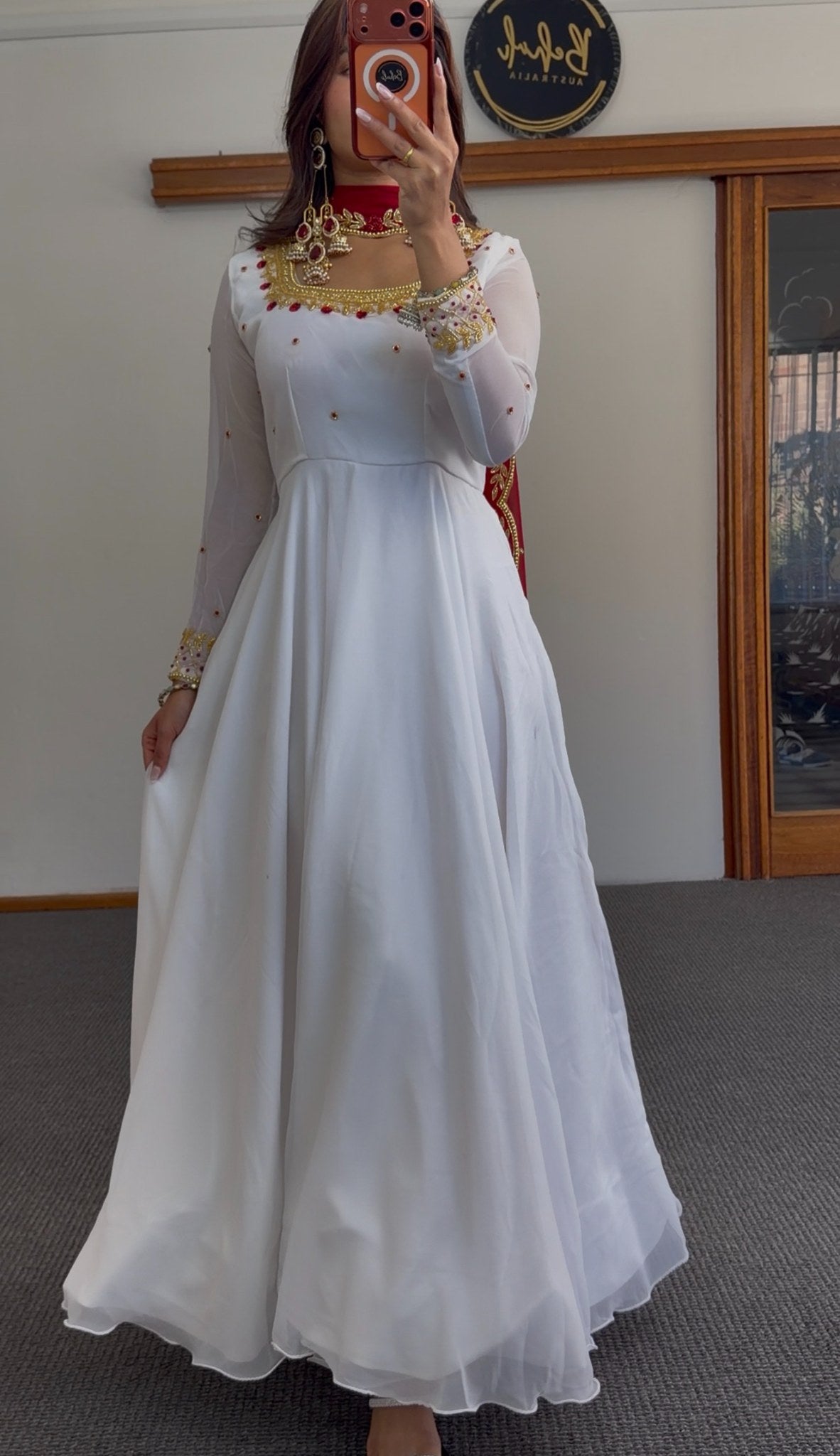 White flared Anarkali gown with deep red yoke, gold zari-style border embroidery and scattered stone embellishments — Behuli — view 4
