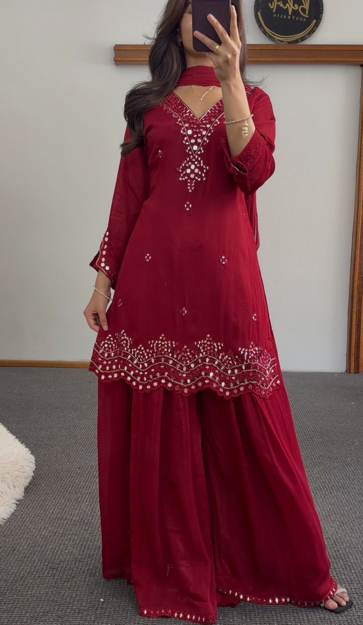 Maroon palazzo suit set with mirror work embroidery, scalloped hemline and matching dupatta worn by a model