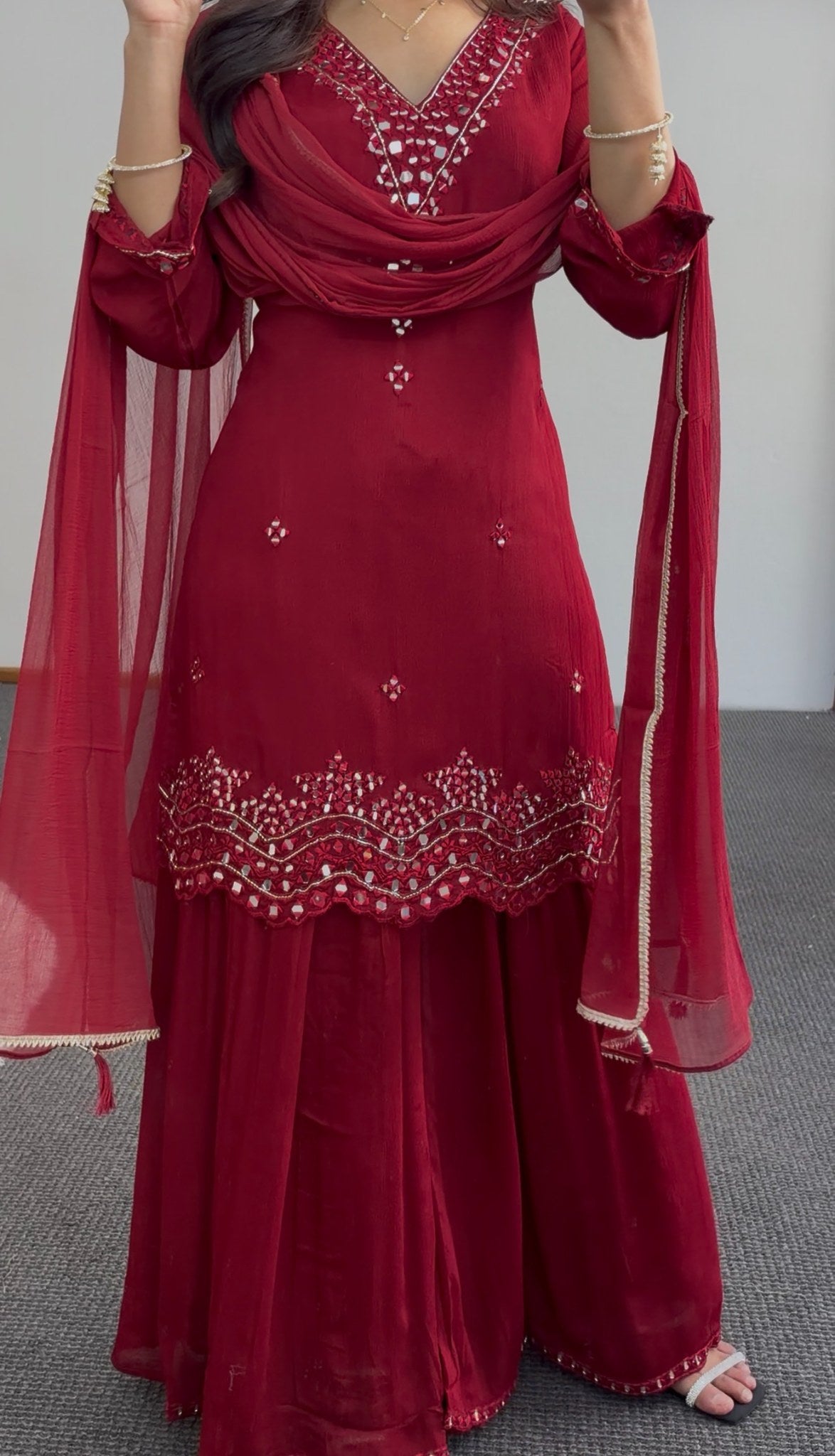 Maroon palazzo suit set with mirror work embroidery, scalloped hemline and matching dupatta worn by a model — view 2