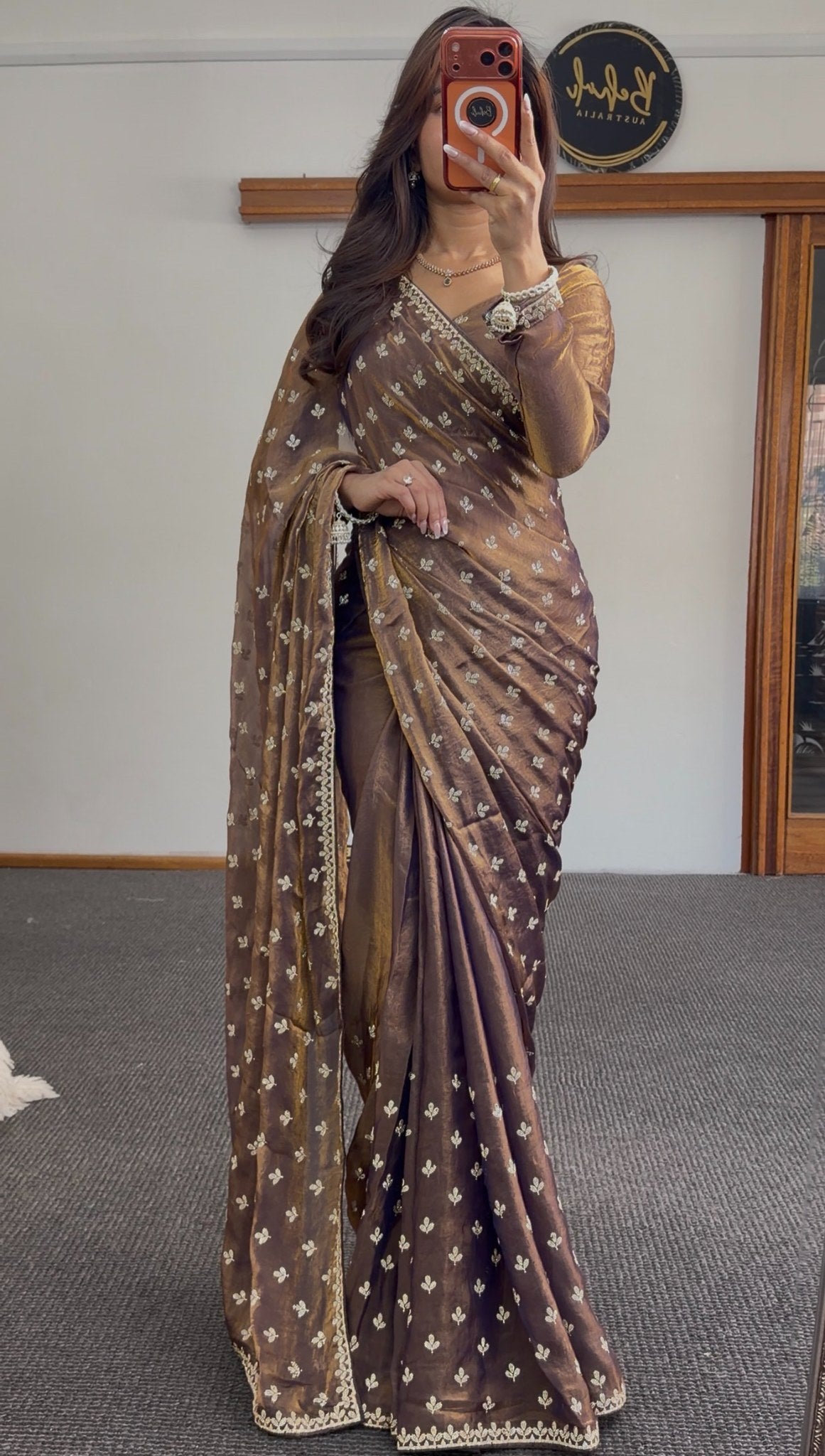 Brown tissue saree with golden sheen, ivory zari booti embroidery and scalloped border draped with matching pallu