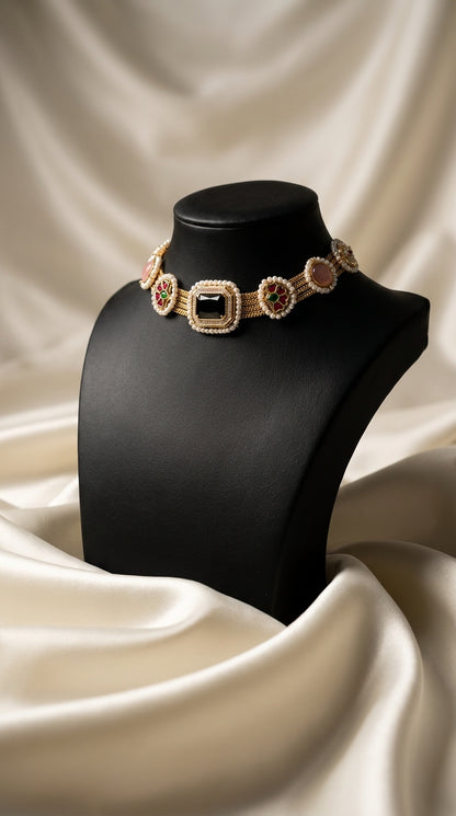 Gold-toned choker necklace with kundan-style stones, pearl beadwork and black centre stone displayed on bust