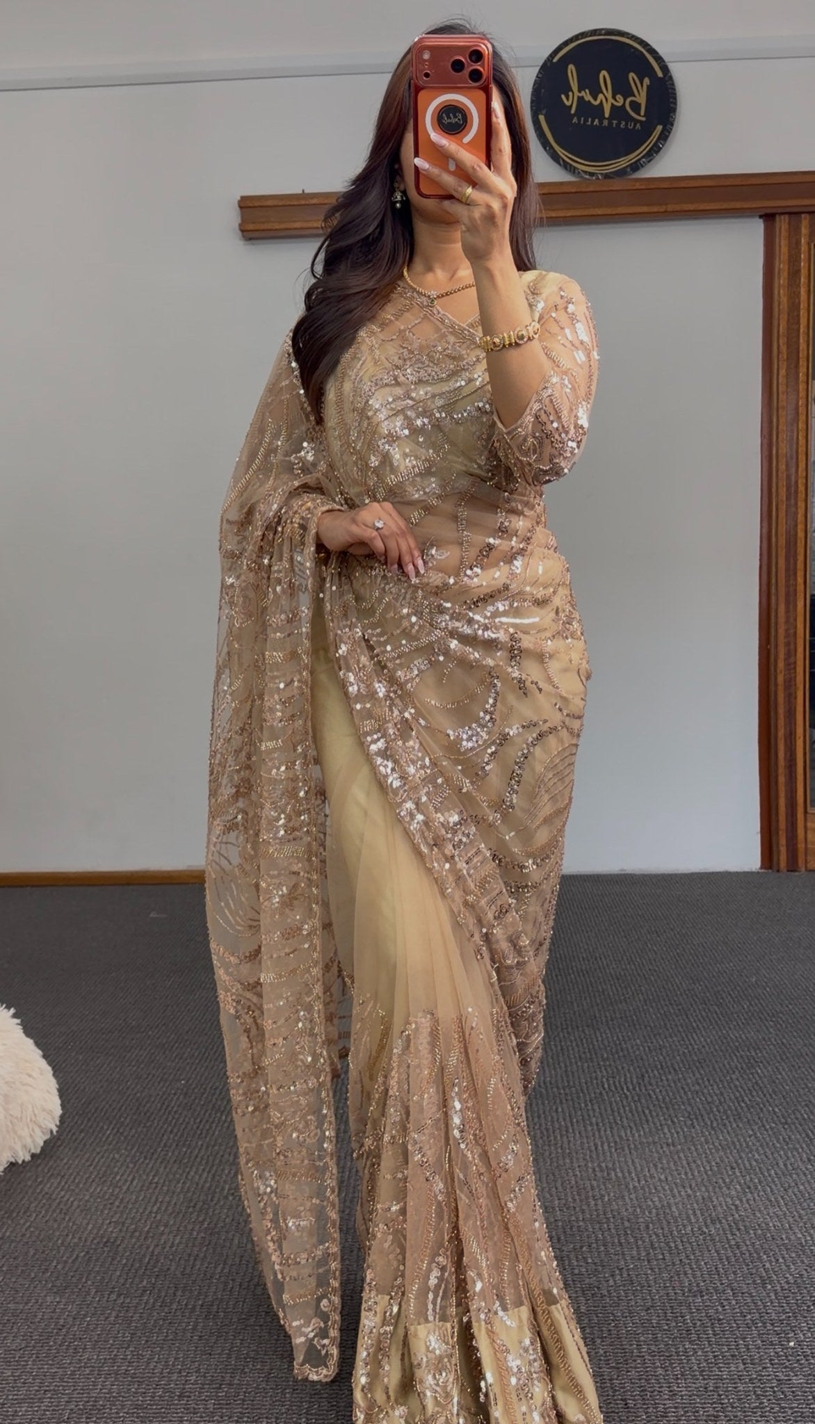 Gold net saree with intricate sequin embroidery in geometric patterns, draped elegantly — Behuli Australia