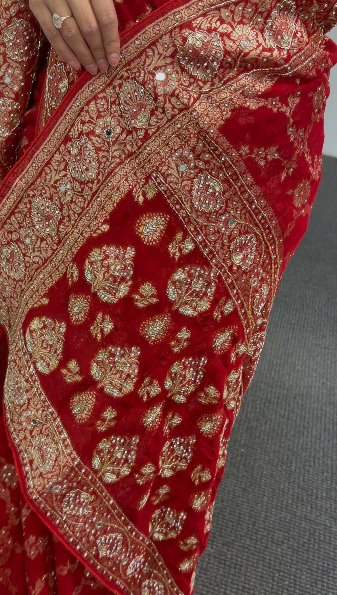 Red khaddi georgette saree with gold zari embroidery and floral border design worn with matching red blouse — view 2