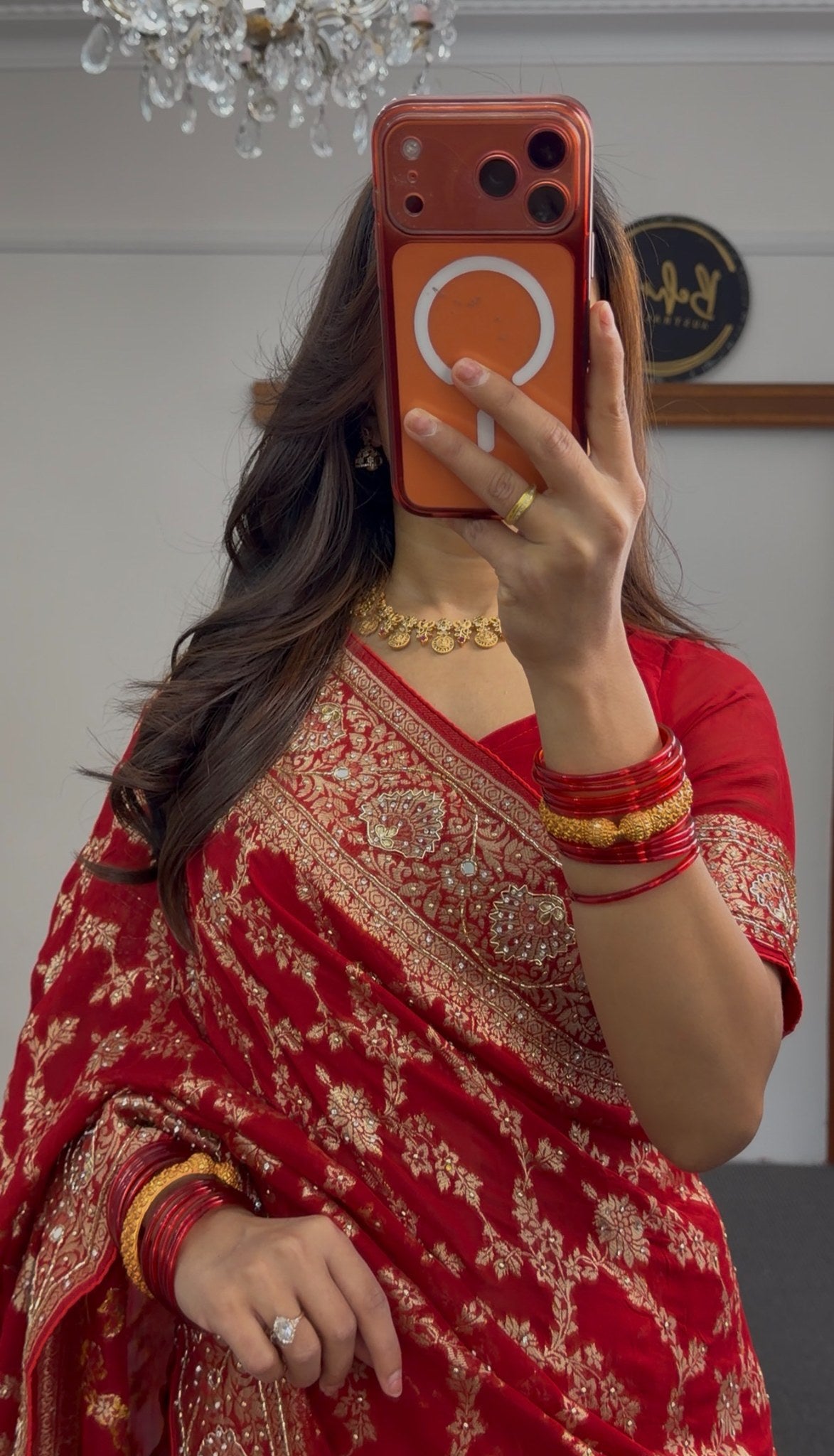 Red khaddi georgette saree with gold zari embroidery and floral border design worn with matching red blouse — view 3