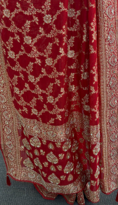 Red khaddi georgette saree with gold zari embroidery and floral border design worn with matching red blouse — view 4