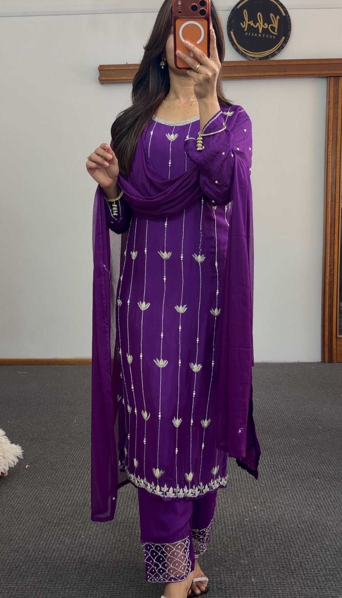 Purple kurti set with white floral embroidery, matching dupatta and embellished pants draped on model