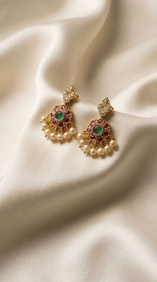 Gold-tone necklace and earring set with red and green stone embellishment and pearl drops displayed on ivory jewellery bust — view 2