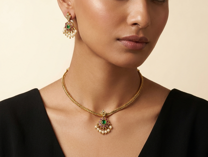 Gold-tone necklace and earring set with red and green stone embellishment and pearl drops displayed on ivory jewellery bust — view 3
