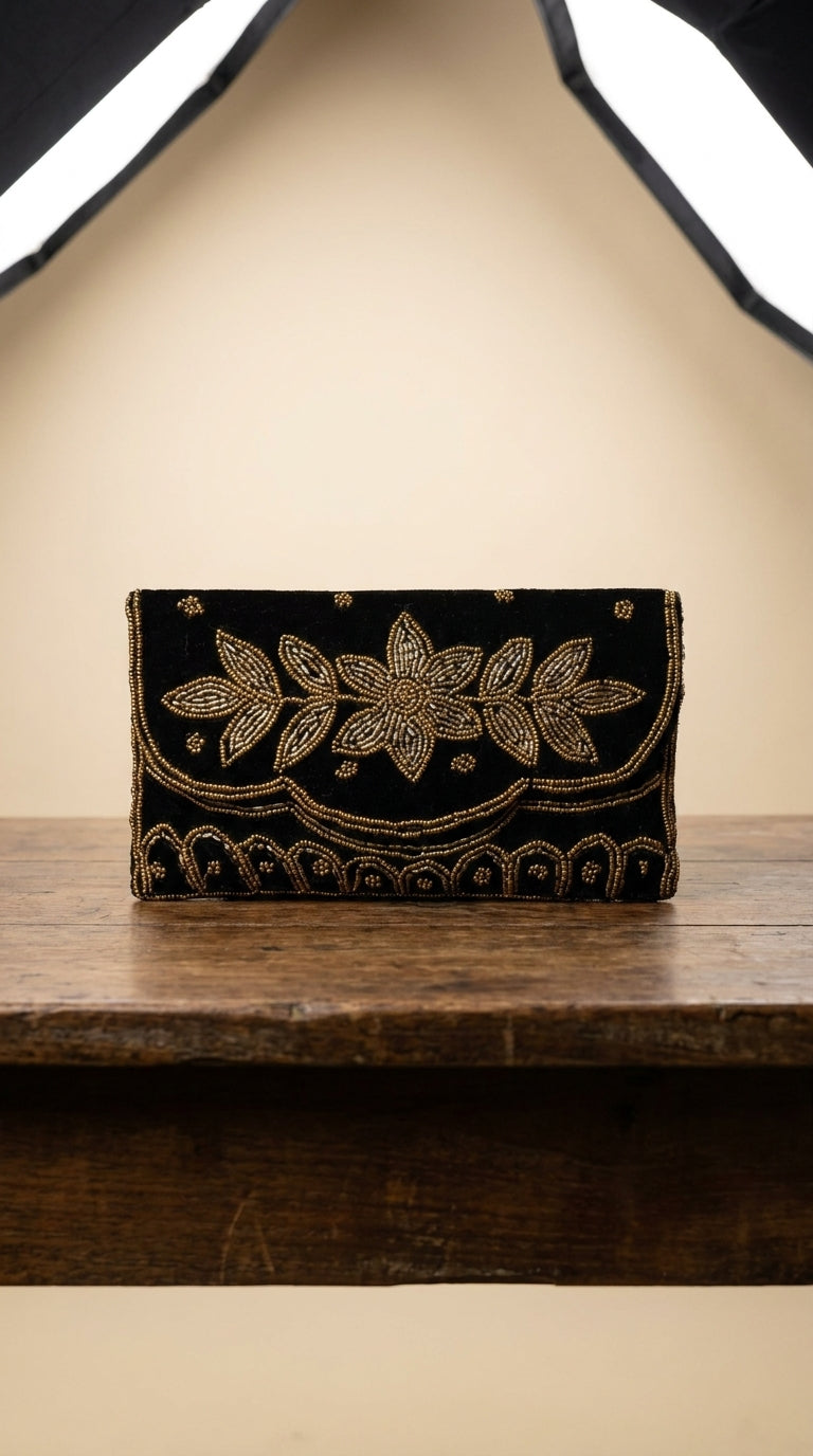 Black embroidered clutch bag with gold beadwork floral design and scalloped border detailing