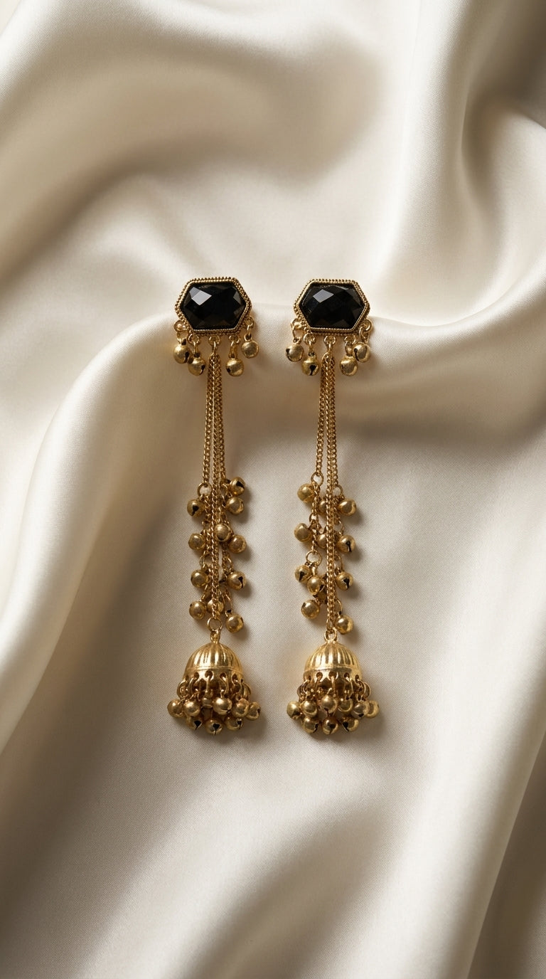 Gold-tone long drop jhumka earrings with black hexagonal stone top, bell chain accents and domed pendant — Behuli Australia
