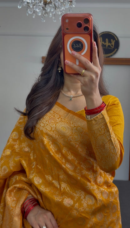 Mustard yellow saree with woven gold zari floral motifs and matching long-sleeve blouse draped elegantly — view 2