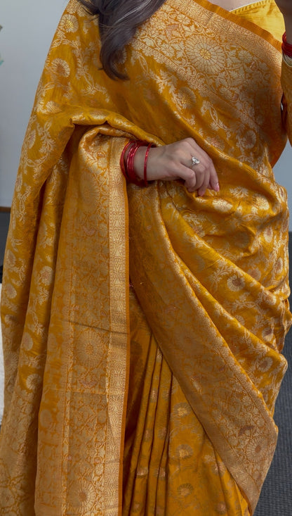 Mustard yellow saree with woven gold zari floral motifs and matching long-sleeve blouse draped elegantly — view 3