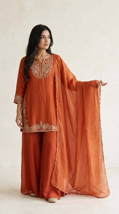 Rust orange palazzo suit set with gold embroidery at neckline, cuffs and hem border, styled with matching dupatta — Behuli