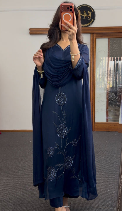 Navy blue A-line kurti set with floral sequin embroidery cascading down the front and matching draped scarf — view 4
